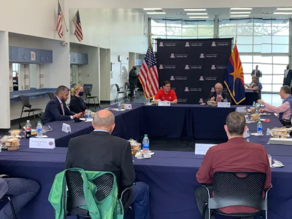 Photo of President Robbins speaking with Governor Doug Ducey at a roundtable